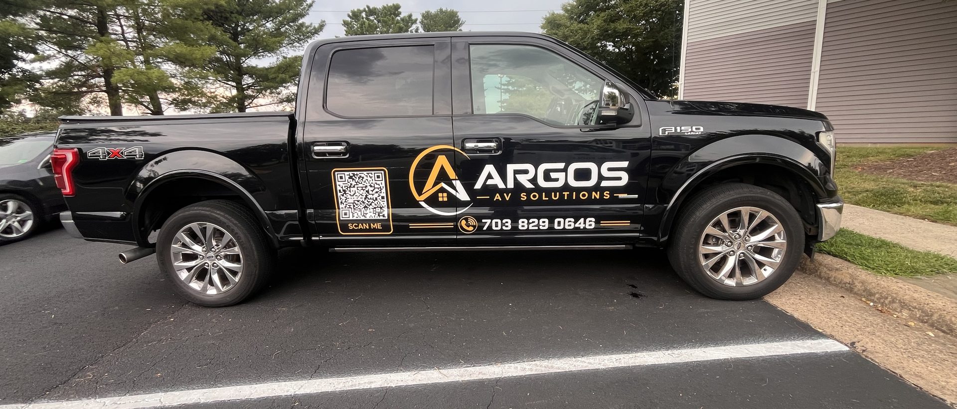 Argos AV Solutions black F-150 work truck with logo, phone number and QR code on the door