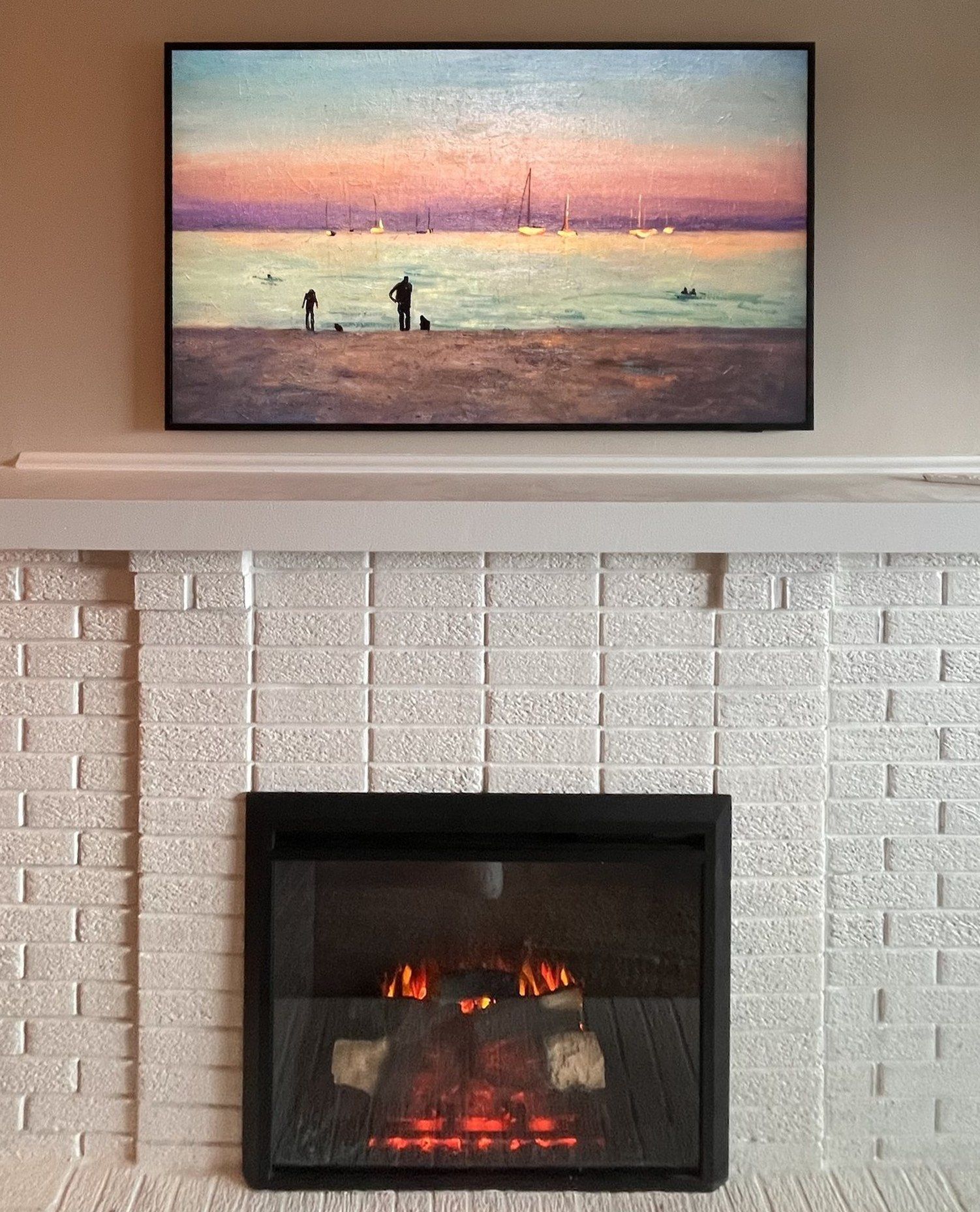 Samsung Frame TV in art mode mounted above a white brick fireplace — Argos AV Frame TV installation