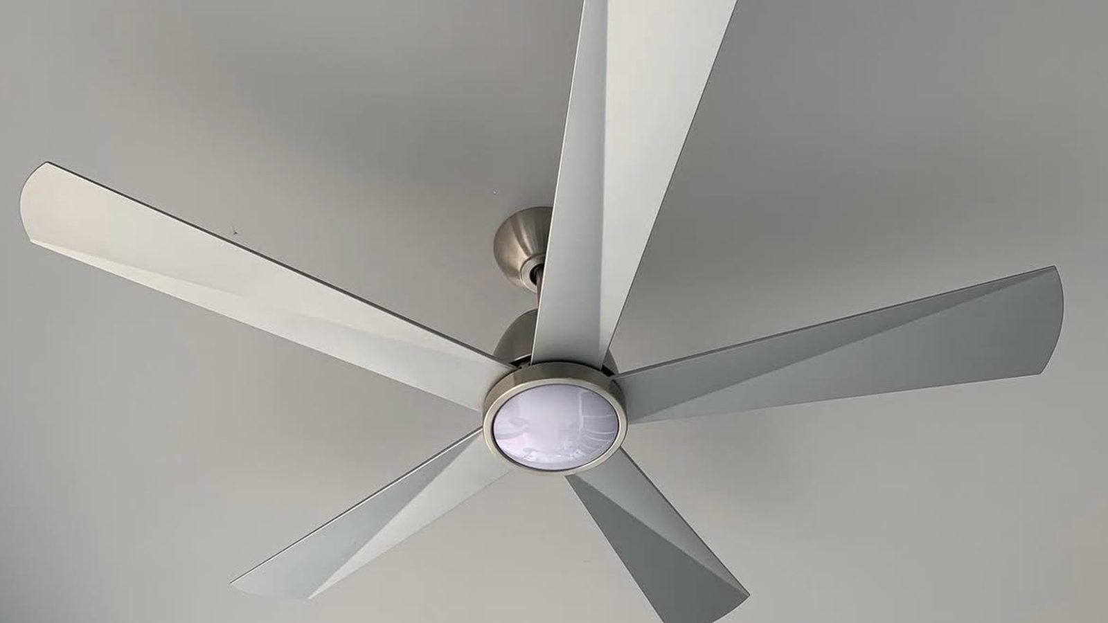 Modern brushed-nickel ceiling fans with integrated lights installed on a covered patio ceiling — Argos AV ceiling fan install