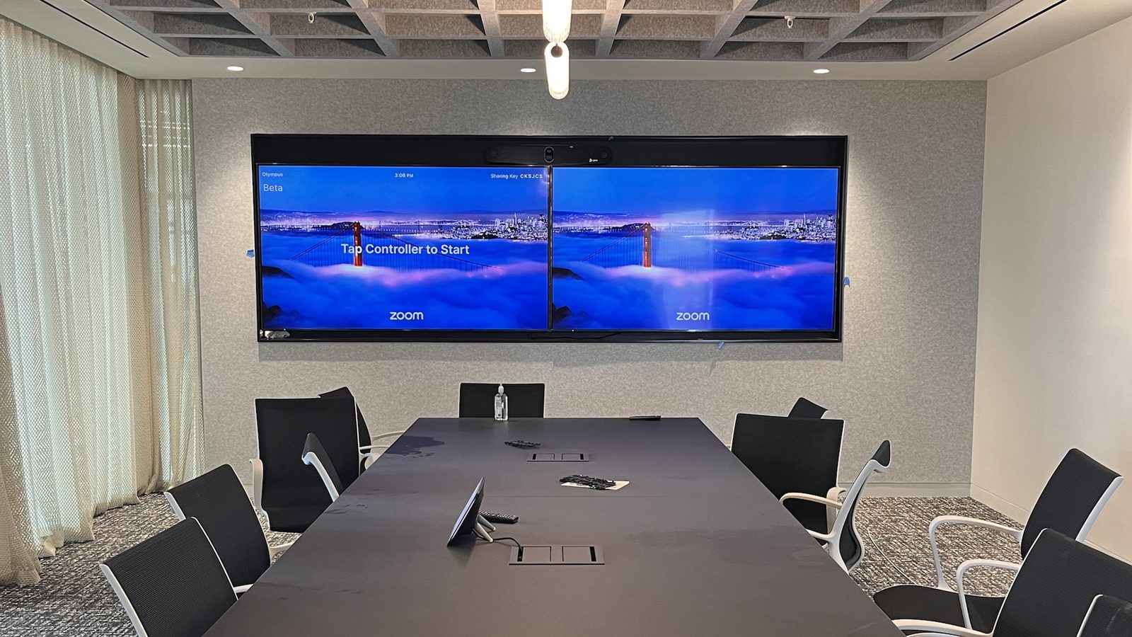 Boardroom with dual-display Zoom Rooms setup, camera bar and table controller — Argos AV conference room AV install