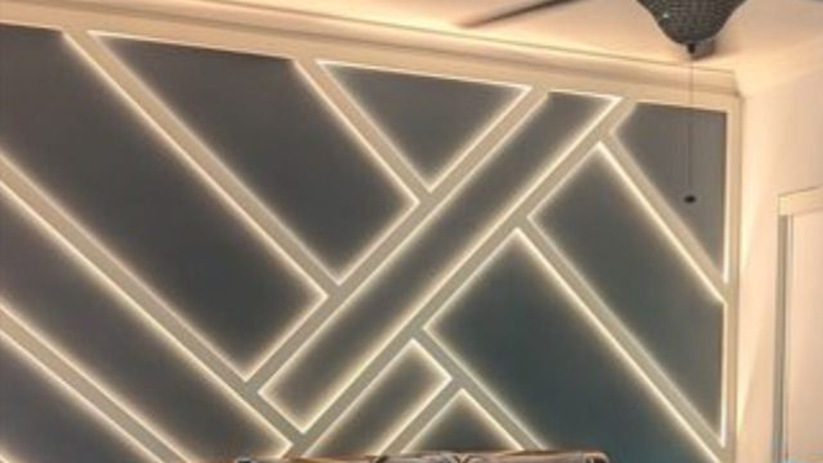 Bedroom accent wall with geometric LED strip lighting behind trim — Argos AV LED accent lighting install