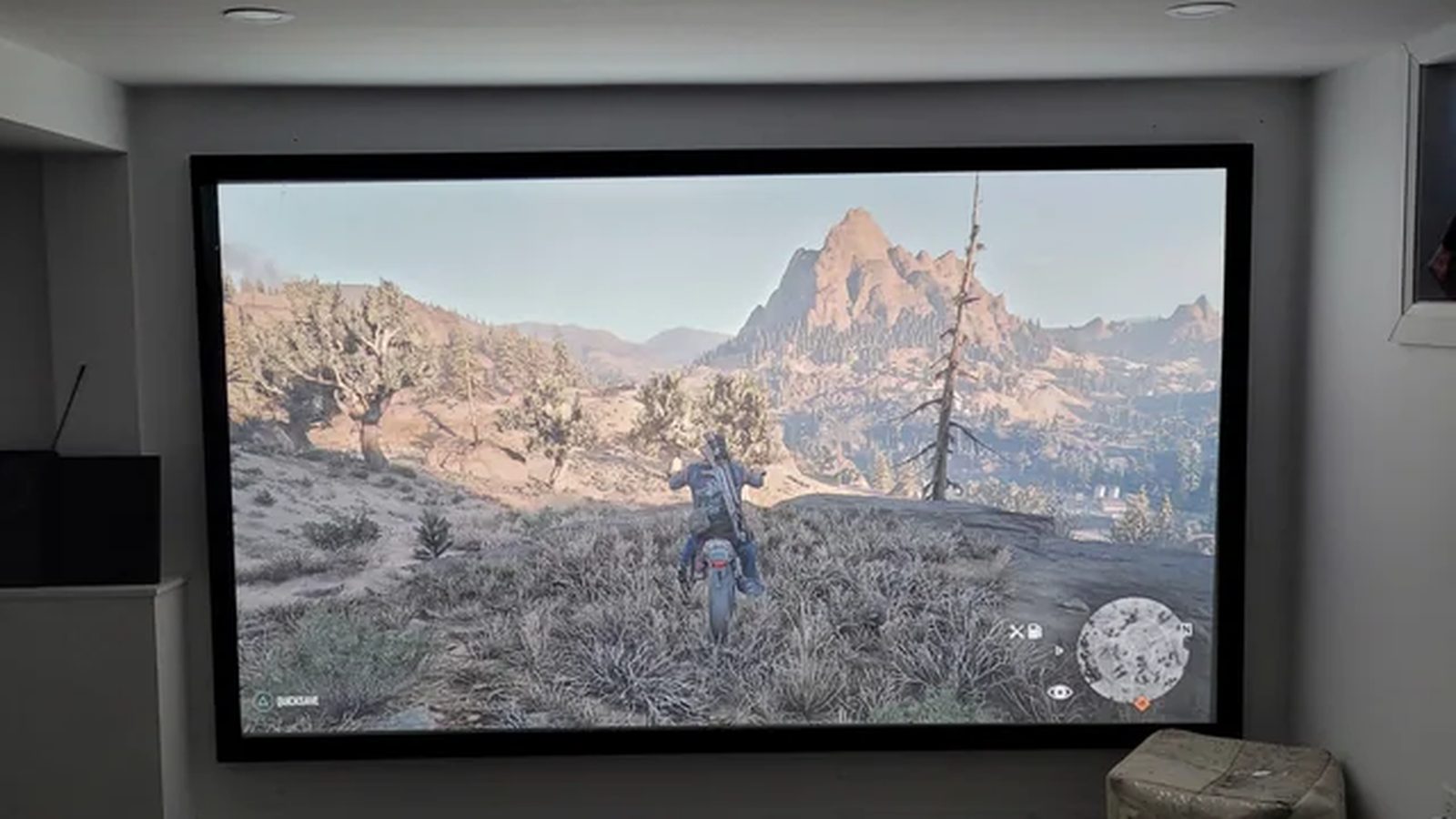 Large fixed projector screen installed in a basement media room — Argos AV projector and screen installation