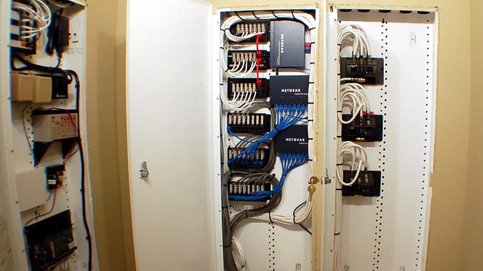 Structured wiring panels with labeled Cat6 patch blocks, network switches and coax distribution — Argos AV structured wiring install